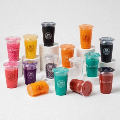 Diverse custom plastic juice cups with unique designs and branding on a clean background
