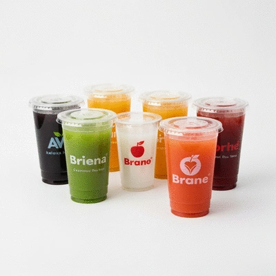 Several custom plastic juice cups with different brand logos on a clean white background